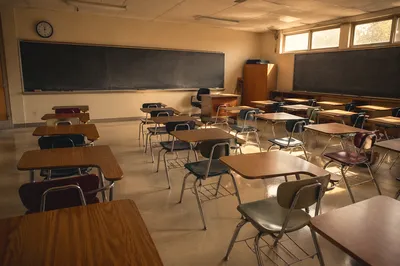 Sunlit Empty Classroom with Chalkboard Rows