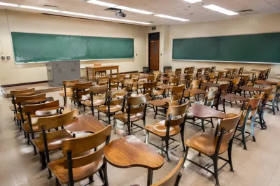 Empty Classroom with Desks and Chalkboards