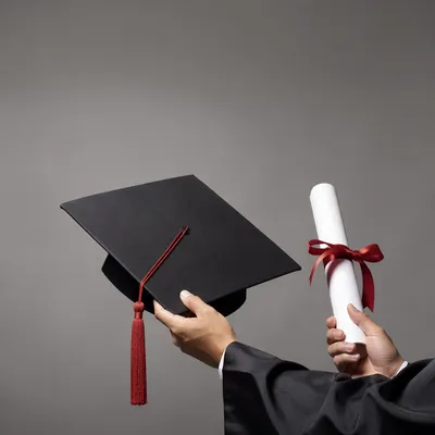 Graduate Holding Cap and Diploma