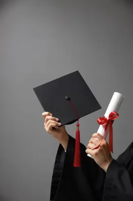 Graduate Holding Cap and Diploma