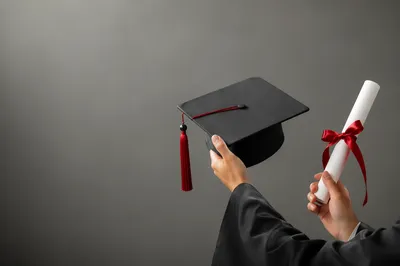 Graduate Hands Holding Cap and Diploma