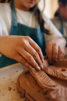 Student Hands Shaping Clay in Art Class