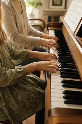 Child Piano Practice with Teacher Hands