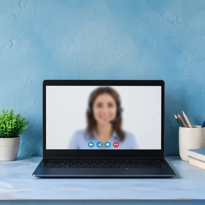Online Learning Laptop on Blue Desk