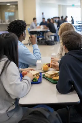 Students Sharing Lunch in School Cafeteria