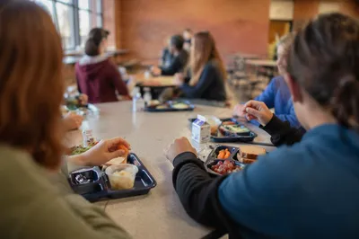 Students Sharing Lunch at Cafeteria Table
