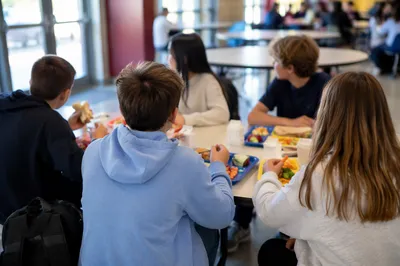 Students Sharing Lunch in School Cafeteria