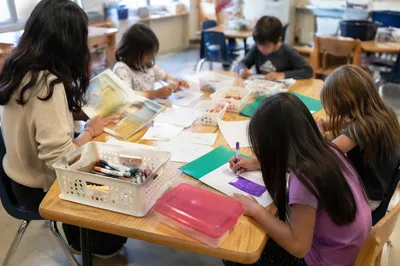 Students Learning Around Classroom Activity Table