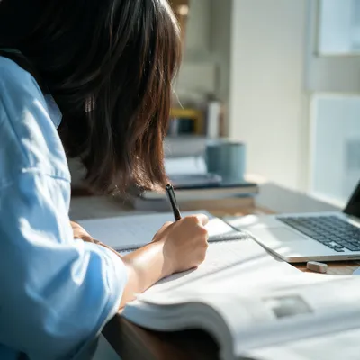 Focused Student Studying With Laptop and Notes
