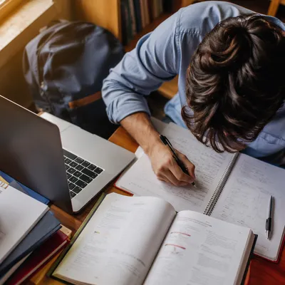 Focused Student Studying With Laptop and Notes