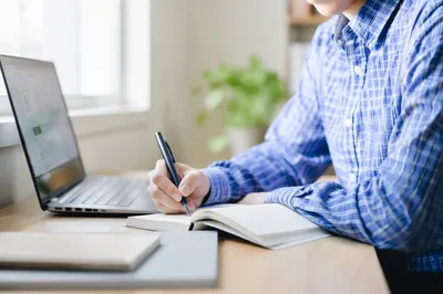 Focused Student Studying With Laptop and Notes