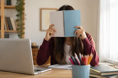 Focused Student Studying With Laptop and Notes