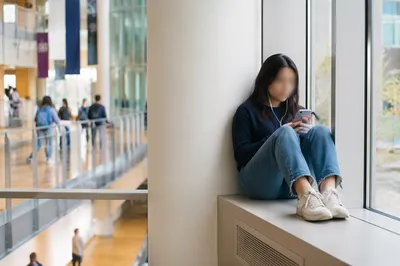 Student Resting in Modern University Atrium