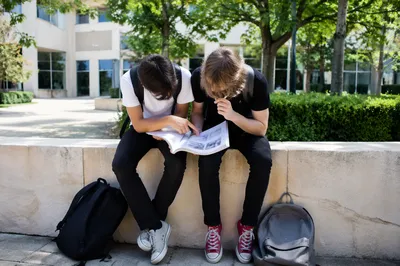 Students Reading Campus Guide Outside University