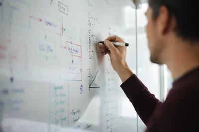 Teacher Writing Colorful Whiteboard Diagrams