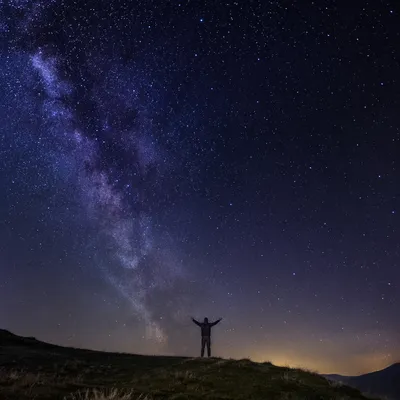 Silhouette in Awe Beneath Starry Creation