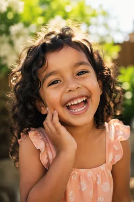 Laughing Child in Sunlit Garden Portrait