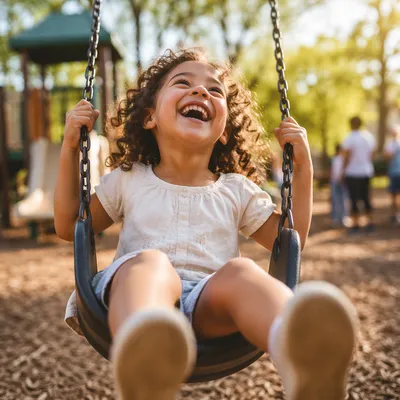Laughing Child on Playground Swing