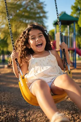 Laughing Girl on Playground Swing