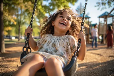 Laughing Child on Playground Swing