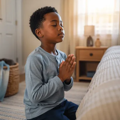 Young Boy Praying Beside Bed