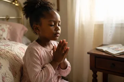 Young Girl Praying Beside Bed at Dawn