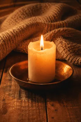 Warm Candlelight Beside a Cozy Blanket