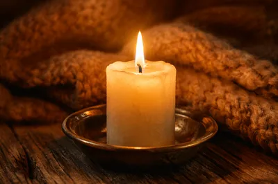 Warm Candlelight Beside Cozy Knitted Blanket