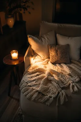 Cozy Armchair with Blanket and Candlelight