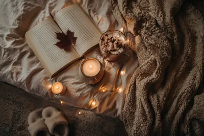 Warm Candlelit Comfort With Book and Blanket