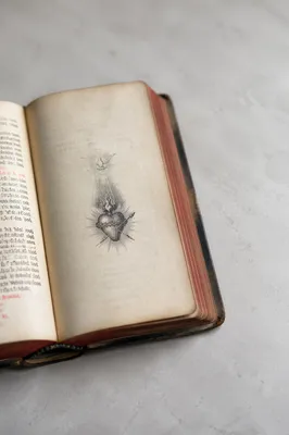 Open Vintage Devotional Book with Heart Symbol