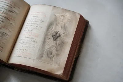 Open Vintage Devotional Book with Heart Illustration