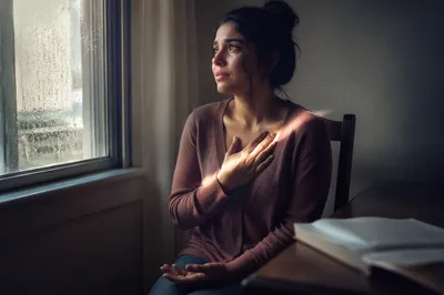Contemplative Woman by Rain Speckled Window