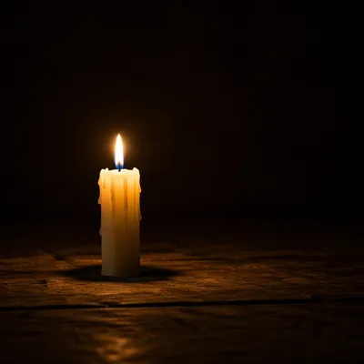 Single Candle Burning in Dark Room