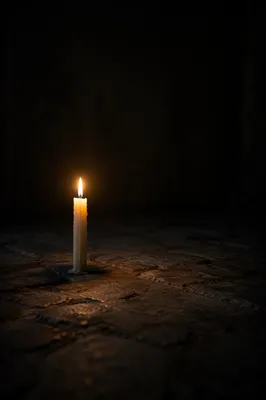 Single Ivory Candle in Dark Interior