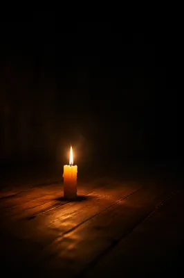 Single Candle in Vast Dark Room
