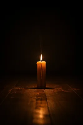 Single Candle in Vast Dark Room