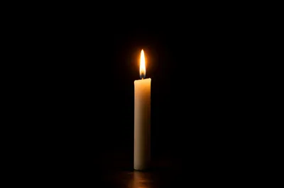 Courage Candle Burning in Vast Darkness