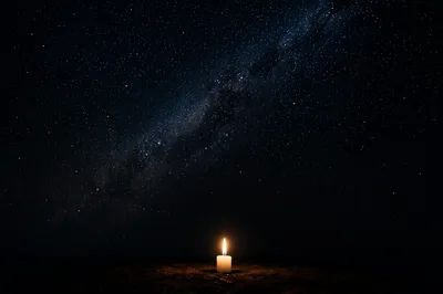 Single Candle of Courage Beneath Starry Darkness