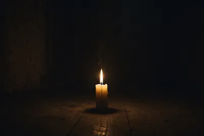 Single Candle Burning in Dark Room