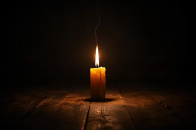 Single Candle in Dark Empty Room
