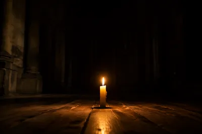 Single Candle Courage in Vast Chapel Darkness