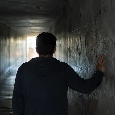 Solitary Man in Dim Tunnel