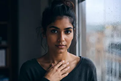 Determined Young Woman by Rainy Window