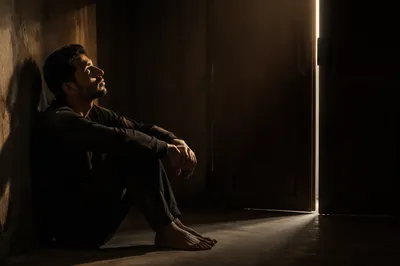 Young Man in Dark Room Light