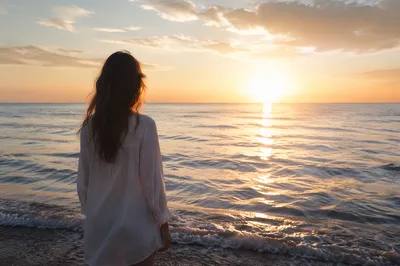 Woman at Sunrise by Calm Ocean