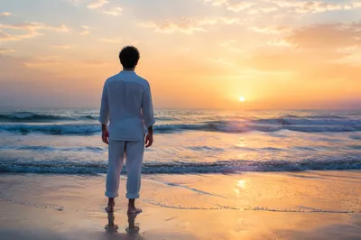 Lone Figure Watching Ocean Sunrise