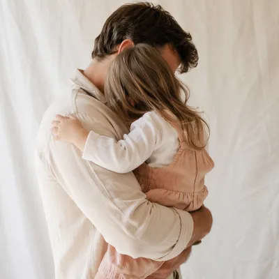 Tender Father Daughter Embrace in Warm Light
