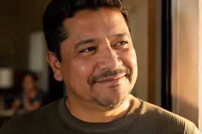 Proud Father Smiling in Sunlit Doorway