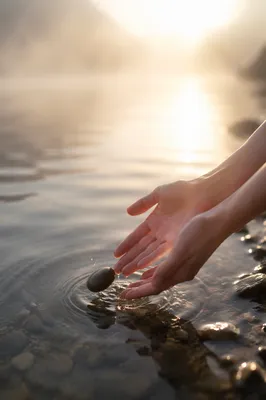 Forgiveness Hands Releasing Stone into Light